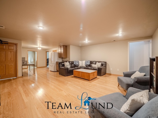 living room featuring light wood-style floors and baseboards