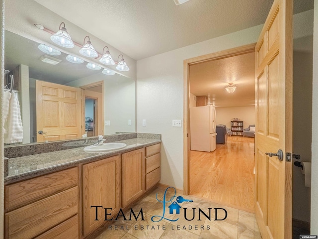 bathroom featuring vanity and a textured ceiling
