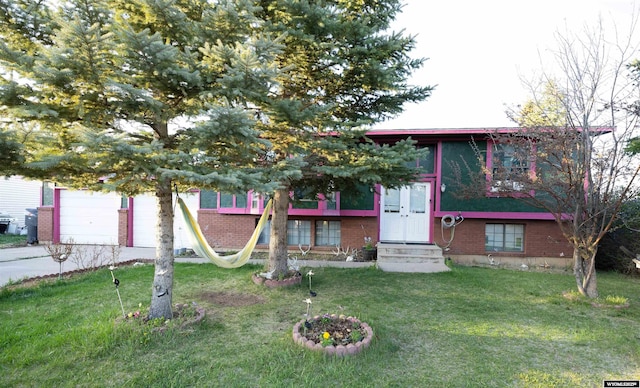 108 Cherokee Ct, Evanston, WY 82930 - view of front of property with entry steps, a garage, driveway, and a front lawn