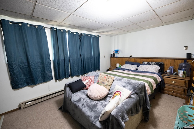 108 Cherokee Ct, Evanston, WY 82930 - bedroom featuring carpet floors, a drop ceiling, and a baseboard radiator