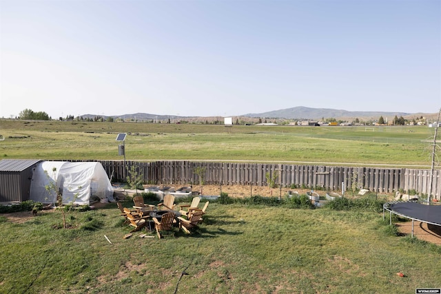108 Cherokee Ct, Evanston, WY 82930 - view of yard featuring a trampoline, a mountain view, and a rural view