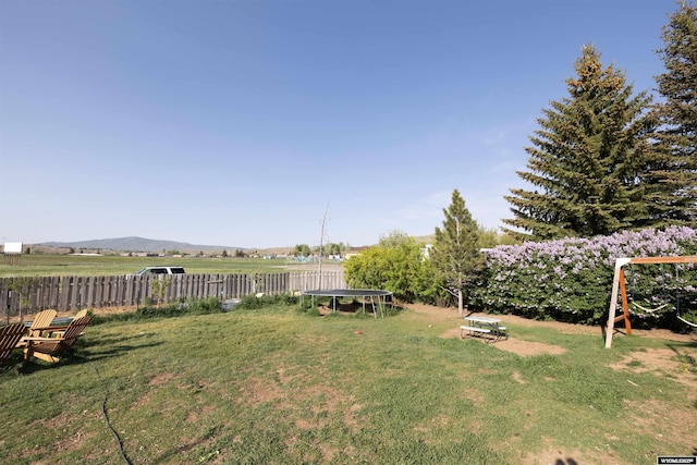 108 Cherokee Ct, Evanston, WY 82930 - view of yard with a trampoline and a mountain view