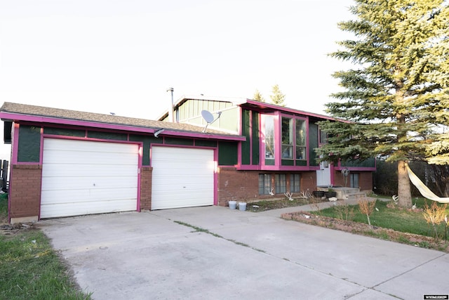 108 Cherokee Ct, Evanston, WY 82930 - view of front of property featuring brick siding, concrete driveway, and an attached garage