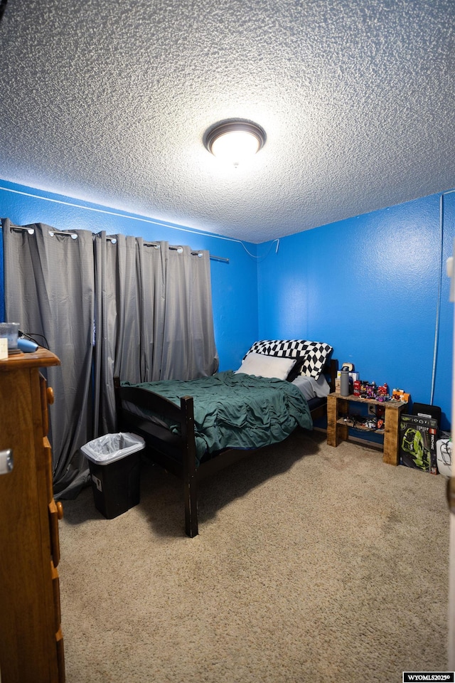 108 Cherokee Ct, Evanston, WY 82930 - bedroom featuring a textured ceiling and carpet flooring