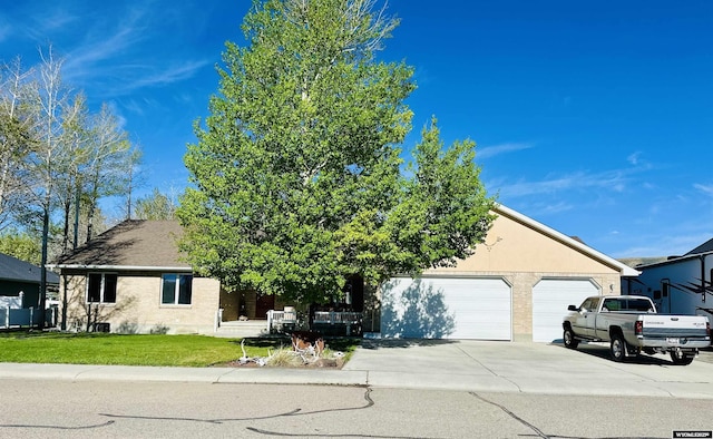 920 Laramie St, Rock Springs, WY 82901 - view of property hidden behind natural elements with driveway, an attached garage, a front yard, and stucco siding