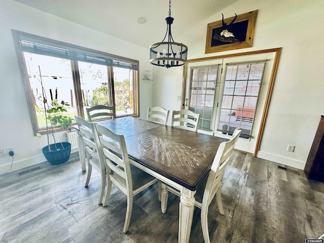 920 Laramie St, Rock Springs, WY 82901 - dining space featuring baseboards, wood finished floors, and a chandelier