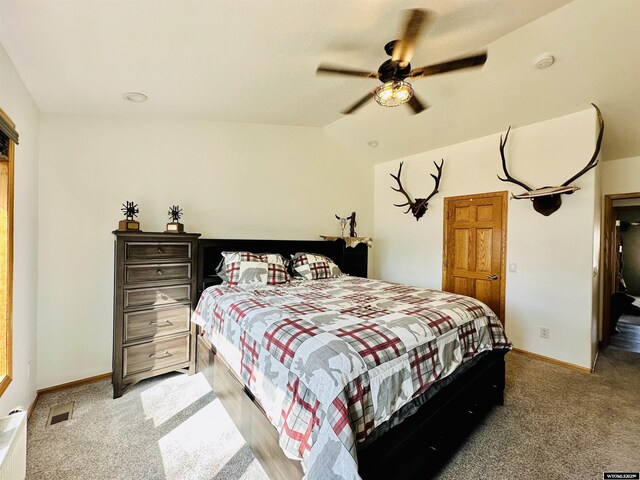 920 Laramie St, Rock Springs, WY 82901 - bedroom featuring light carpet, lofted ceiling, baseboards, and a ceiling fan