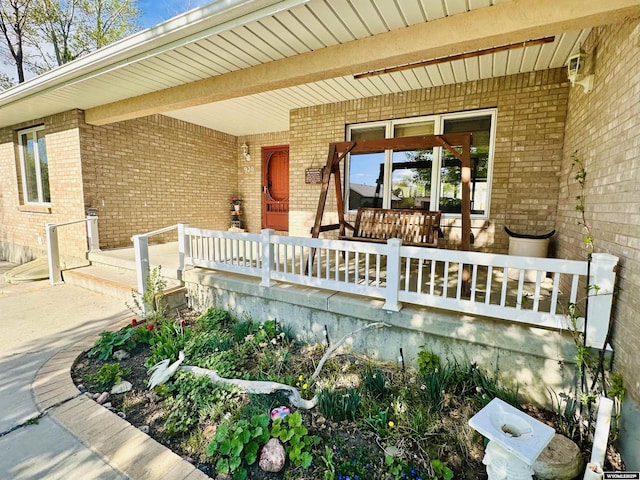 920 Laramie St, Rock Springs, WY 82901 - doorway to property with a porch and brick siding