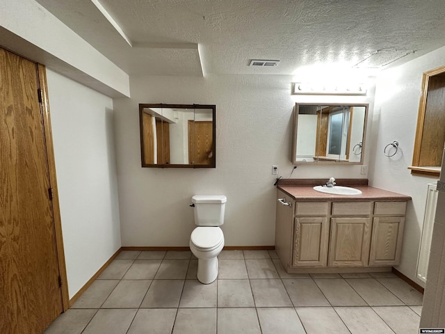 920 Laramie St, Rock Springs, WY 82901 - bathroom with tile patterned flooring, a textured ceiling, toilet, and vanity