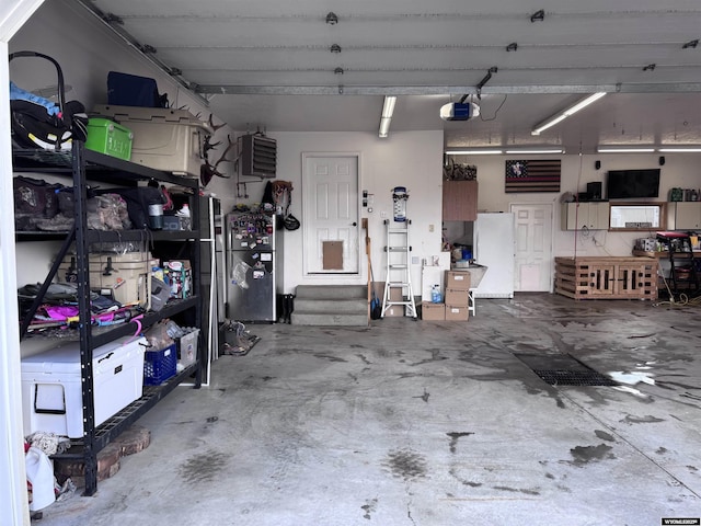 920 Laramie St, Rock Springs, WY 82901 - garage featuring freestanding refrigerator and a garage door opener