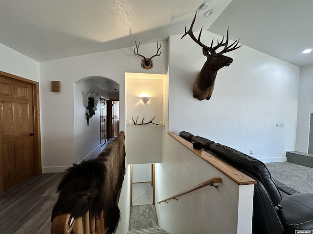 920 Laramie St, Rock Springs, WY 82901 - hallway with arched walkways, baseboards, an upstairs landing, lofted ceiling, and carpet