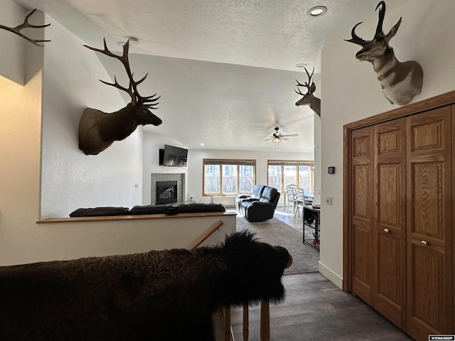 920 Laramie St, Rock Springs, WY 82901 - living room with a tile fireplace, a textured ceiling, dark wood finished floors, baseboards, and ceiling fan