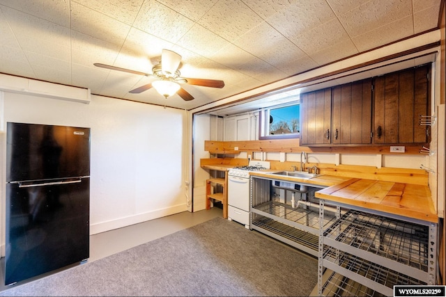 223 S Thurmond St, Sheridan, WY 82801 - kitchen featuring freestanding refrigerator, white gas stove, a sink, a ceiling fan, and baseboards