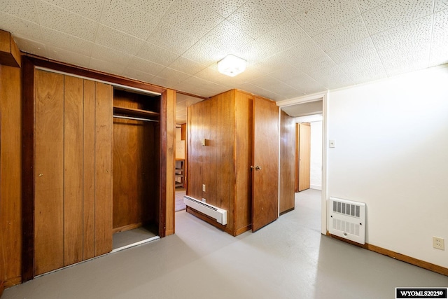 223 S Thurmond St, Sheridan, WY 82801 - unfurnished bedroom featuring a baseboard heating unit, heating unit, a closet, concrete flooring, and baseboards