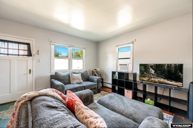 223 S Thurmond St, Sheridan, WY 82801 - living area featuring healthy amount of natural light, cooling unit, wood finished floors, and a baseboard radiator