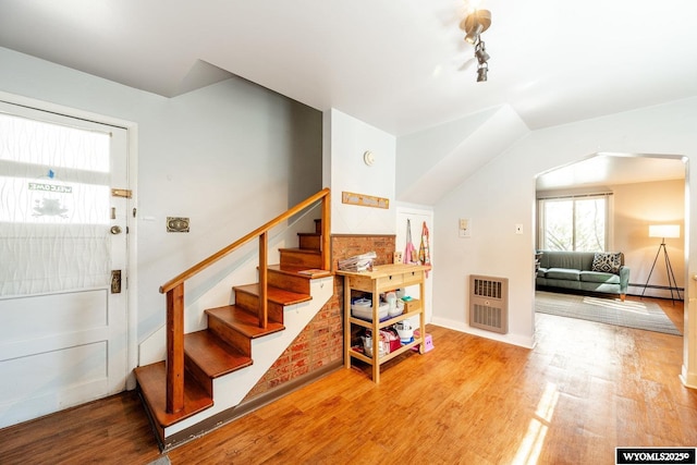 223 S Thurmond St, Sheridan, WY 82801 - stairway featuring heating unit, healthy amount of natural light, and wood finished floors