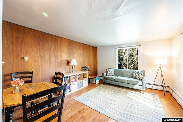 223 S Thurmond St, Sheridan, WY 82801 - living area featuring light wood-style floors, baseboard heating, and wooden walls