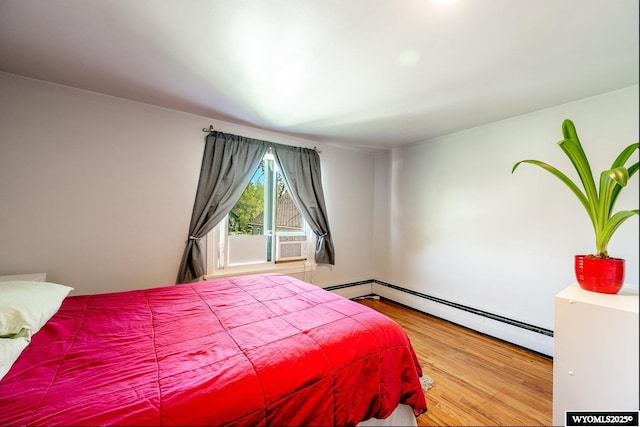 223 S Thurmond St, Sheridan, WY 82801 - bedroom featuring baseboard heating, wood finished floors, and cooling unit
