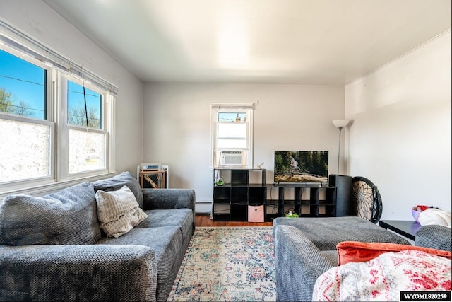 223 S Thurmond St, Sheridan, WY 82801 - living area featuring wood finished floors, cooling unit, and baseboard heating