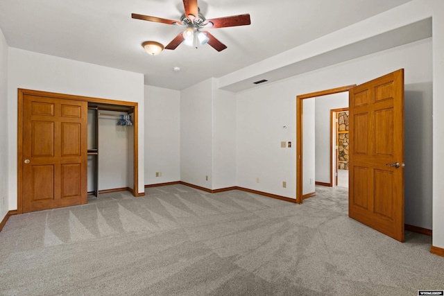unfurnished bedroom with carpet floors, baseboards, a closet, and a ceiling fan