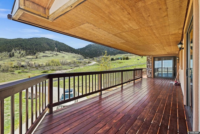 wooden deck with a mountain view