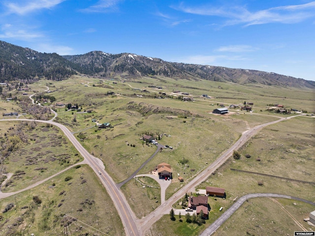 aerial view of property and surrounding area with a mountain backdrop and rural landscape