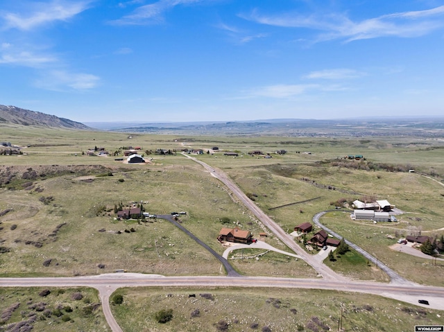 aerial view of property's location with rural landscape and a mountainous background