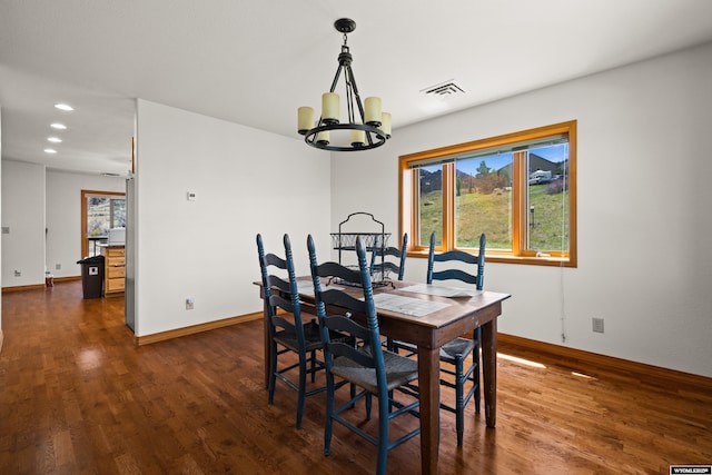 dining room featuring a chandelier, dark wood finished floors, recessed lighting, and baseboards