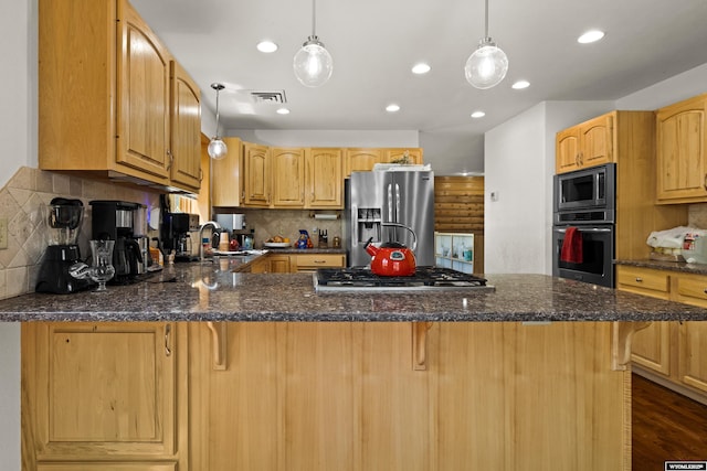 kitchen with appliances with stainless steel finishes, tasteful backsplash, a peninsula, a kitchen breakfast bar, and decorative light fixtures