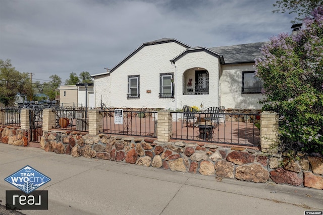 view of front of home featuring a fenced front yard and stucco siding