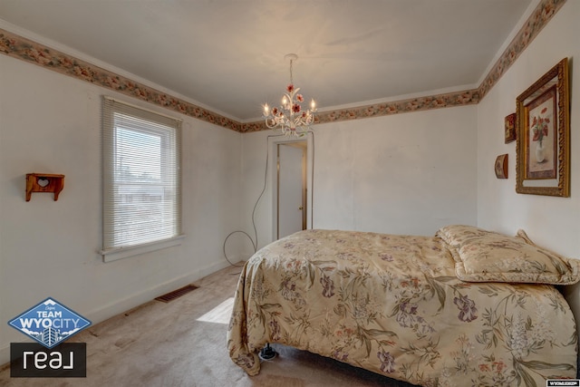 bedroom featuring a chandelier, carpet, and baseboards