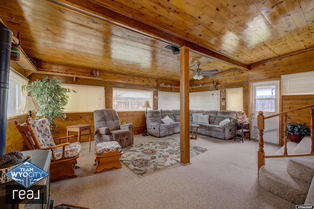 living room with carpet floors, wooden walls, wooden ceiling, and ceiling fan