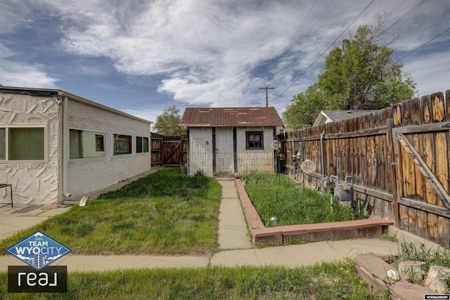 view of yard with a storage shed and an outbuilding
