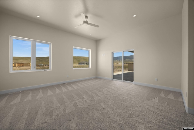 spare room with a ceiling fan, light colored carpet, baseboards, and recessed lighting