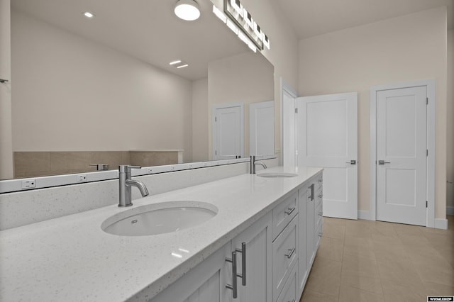 full bath with double vanity and tile patterned flooring