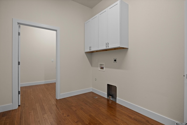 clothes washing area with cabinet space, electric dryer hookup, washer hookup, dark wood finished floors, and baseboards
