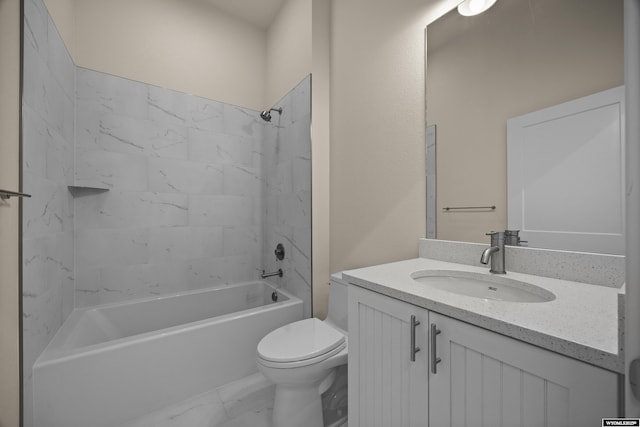 bathroom with toilet, vanity, marble look tiles, and tub / shower combination