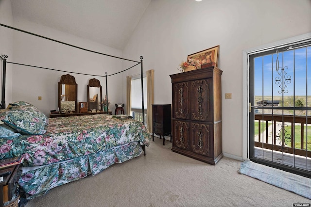 bedroom with access to outside, carpet floors, and high vaulted ceiling