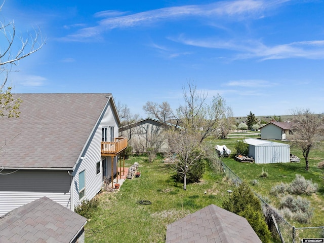 view of yard featuring a shed, an outdoor structure, and a wooden deck