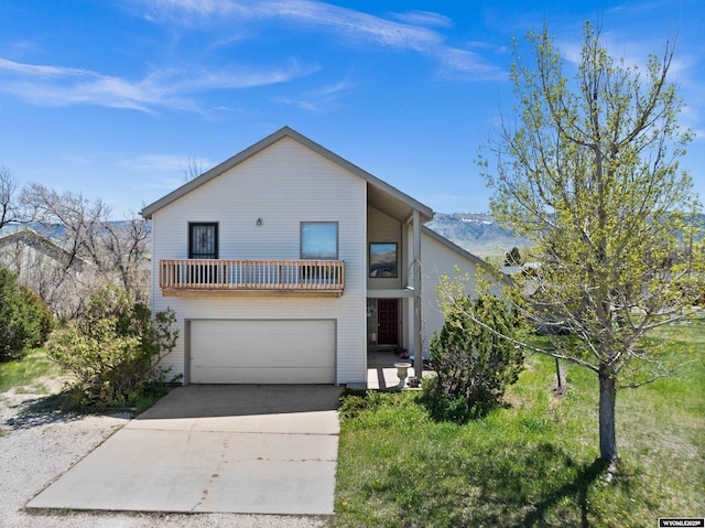 view of front of property with a balcony, an attached garage, and concrete driveway