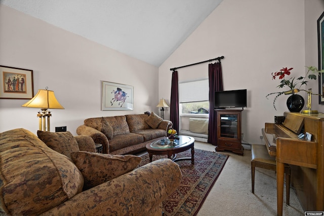 carpeted living room featuring high vaulted ceiling
