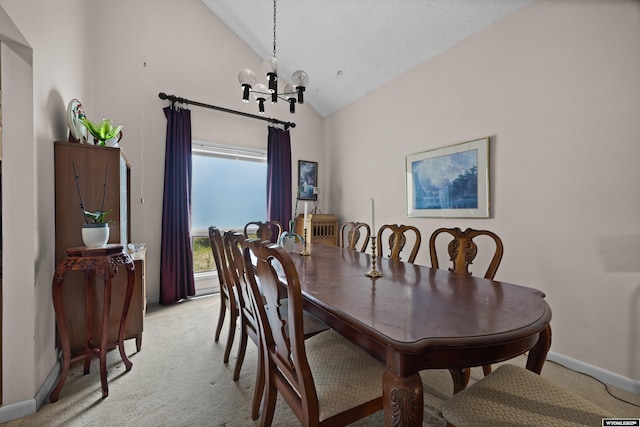 dining area featuring a chandelier, light carpet, baseboards, and high vaulted ceiling