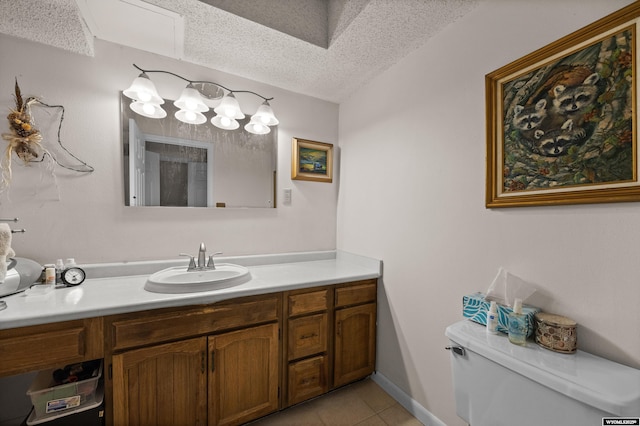 bathroom featuring a textured ceiling, tile patterned floors, vanity, and toilet