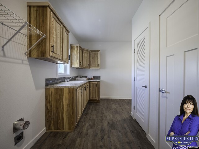 430 W Platte, Glenrock, WY 82637 - kitchen featuring dark wood-style flooring, baseboards, and brown cabinets