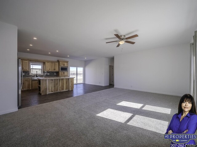 430 W Platte, Glenrock, WY 82637 - unfurnished living room featuring dark carpet, baseboards, recessed lighting, and a ceiling fan