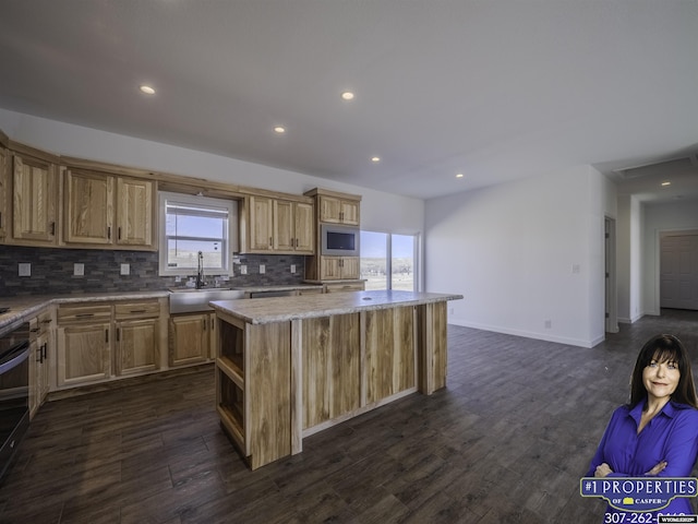 430 W Platte, Glenrock, WY 82637 - kitchen featuring a sink, a center island, backsplash, dark wood finished floors, and recessed lighting