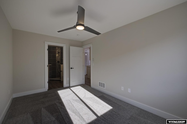 unfurnished bedroom featuring carpet floors, baseboards, ceiling fan, and ensuite bath
