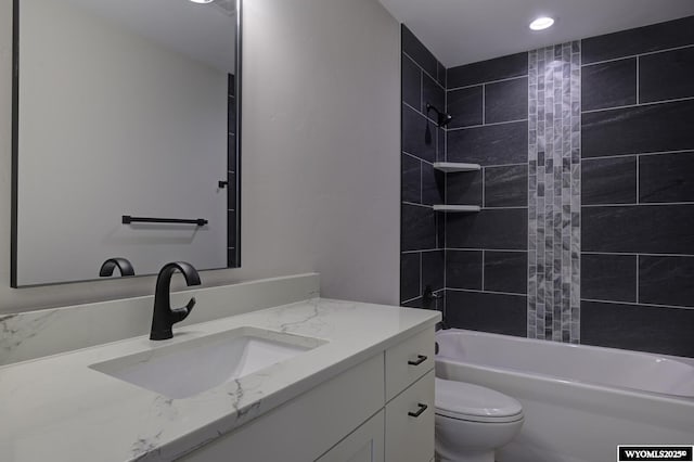 bathroom featuring toilet, shower / washtub combination, vanity, and recessed lighting