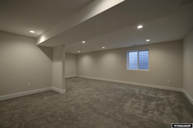 below grade area with dark colored carpet, baseboards, and recessed lighting