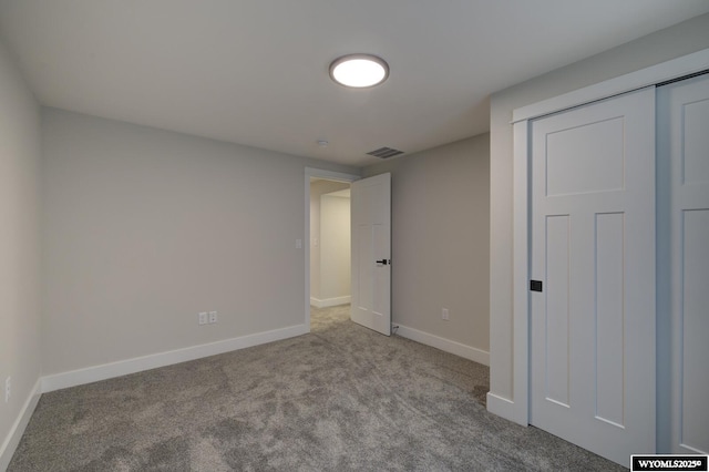 unfurnished bedroom featuring carpet floors and baseboards